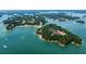 Beautiful aerial view of a waterfront property on a tranquil lake with lush greenery at 2505 Ridgehurst Dr, Buford, GA 30518