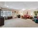 Spacious finished basement with neutral carpet, multiple seating areas, and natural light at 2505 Ridgehurst Dr, Buford, GA 30518