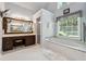 Bright bathroom featuring soaking tub, separate shower, and vanity with generous counter space at 2505 Ridgehurst Dr, Buford, GA 30518