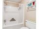 Bathroom with standard tub and shower, white tile walls, and standard fixtures at 2505 Ridgehurst Dr, Buford, GA 30518