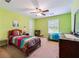 Bright bedroom with vibrant green walls, and two twin beds with colorful bedding at 2505 Ridgehurst Dr, Buford, GA 30518