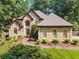 Charming home with manicured front yard and inviting entrance, surrounded by lush greenery at 2505 Ridgehurst Dr, Buford, GA 30518