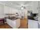 Well-lit kitchen featuring a central island with sleek black countertop and white cabinetry at 2505 Ridgehurst Dr, Buford, GA 30518