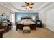 Spacious main bedroom with tray ceiling, carpet, and warm lighting at 2505 Ridgehurst Dr, Buford, GA 30518