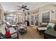 Relaxing screened sunroom featuring comfortable wicker furniture, ceiling fan, and outdoor view at 2505 Ridgehurst Dr, Buford, GA 30518