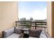 Cozy balcony setting with cushioned seating and a small table to enjoy the city view at 3445 Stratford Rd # 3102, Atlanta, GA 30326