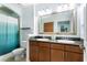 Bright bathroom featuring double sinks, granite countertops, and a shower with a curtain at 3445 Stratford Rd # 3102, Atlanta, GA 30326