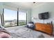 Well-lit bedroom with neutral tones, showcasing a comfortable setup and expansive city views at 3445 Stratford Rd # 3102, Atlanta, GA 30326