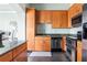 Elegant kitchen boasts wood cabinets, stainless steel appliances, and sleek dark flooring at 3445 Stratford Rd # 3102, Atlanta, GA 30326