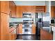 Well-lit kitchen featuring stainless steel appliances, granite countertops, and rich wood cabinetry at 3445 Stratford Rd # 3102, Atlanta, GA 30326