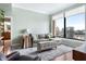 Stylish living room with large windows offering city views, complemented by modern furniture and decor at 3445 Stratford Rd # 3102, Atlanta, GA 30326