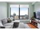 Relaxing living room featuring a comfortable sectional and expansive windows with scenic city views at 3445 Stratford Rd # 3102, Atlanta, GA 30326