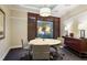 The meeting room has a round table with four chairs in front of a big window and a sideboard at 3445 Stratford Rd # 3102, Atlanta, GA 30326