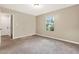 Cozy bedroom features carpet flooring, a bright window, and neutral paint at 3498 Newberry Trl, Decatur, GA 30034