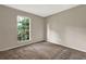 Bedroom featuring neutral walls, carpet, and a window view of lush trees at 3498 Newberry Trl, Decatur, GA 30034