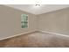 Well-lit bedroom with carpet flooring, a window, and a calming, neutral color scheme at 3498 Newberry Trl, Decatur, GA 30034