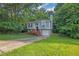Charming split-level home with gray siding, brick accents, and a one-car garage nestled in lush greenery at 3498 Newberry Trl, Decatur, GA 30034