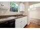 Bright kitchen with white cabinets, laminate countertops, stainless steel sink, and modern appliances for a convenient cooking experience at 3498 Newberry Trl, Decatur, GA 30034