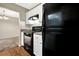 Functional kitchen with white cabinets, laminate countertops, and a black range oven, and refrigerator at 3498 Newberry Trl, Decatur, GA 30034