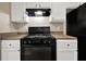 Functional kitchen with white cabinets, laminate countertops, and a black range oven with good lighting at 3498 Newberry Trl, Decatur, GA 30034