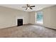 Spacious living room featuring a fireplace, ceiling fan and a sunlit window view at 3498 Newberry Trl, Decatur, GA 30034