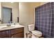 Functional bathroom featuring a vanity with dark wood cabinets, a toilet, and a shower with a patterned curtain at 680 Emeril Dr, Avondale Estates, GA 30002