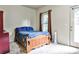 Inviting bedroom features neutral walls, carpet, and a wooden bed frame, offering a serene and comfortable space at 680 Emeril Dr, Avondale Estates, GA 30002