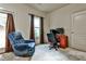 Versatile room with a comfortable recliner and a functional workspace, complemented by natural light and a calming color scheme at 680 Emeril Dr, Avondale Estates, GA 30002