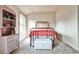 Cozy bedroom with antique metal bed frame, colorful bedding, and a light pink dresser for a warm, inviting feel at 680 Emeril Dr, Avondale Estates, GA 30002