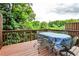 Relaxing outdoor deck with wooded view, wrought-iron table and chairs for entertaining at 680 Emeril Dr, Avondale Estates, GA 30002