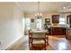Well-lit dining area with hardwood floors, chandelier and access to outdoor deck at 680 Emeril Dr, Avondale Estates, GA 30002
