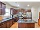 Well-equipped kitchen with dark cabinets, granite countertops, an island, and stainless steel appliances at 680 Emeril Dr, Avondale Estates, GA 30002