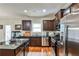 Stainless steel appliances, dark wood cabinets and a granite countertop island highlight this kitchen at 680 Emeril Dr, Avondale Estates, GA 30002