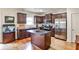 Modern kitchen featuring stainless steel appliances, granite countertops, an island and wood floors at 680 Emeril Dr, Avondale Estates, GA 30002
