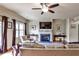 Bright living room with hardwood floors, ceiling fan, fireplace, and outdoor access for seamless entertaining at 680 Emeril Dr, Avondale Estates, GA 30002