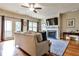Cozy living room with hardwood floors, fireplace, and access to an outdoor deck with view at 680 Emeril Dr, Avondale Estates, GA 30002