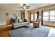 Bright living room with hardwood floors, a ceiling fan, and comfortable seating arrangement with natural light at 680 Emeril Dr, Avondale Estates, GA 30002