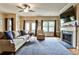 Comfortable living room featuring a fireplace, TV, hardwood floors, and access to an outdoor deck at 680 Emeril Dr, Avondale Estates, GA 30002