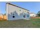Spacious backyard featuring green grass, concrete patio, wood fence, and a home with light blue siding at 230 Mackenzie Ct, Covington, GA 30016