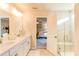 Bright bathroom with double vanity, plenty of counter space, and a glass-enclosed shower at 230 Mackenzie Ct, Covington, GA 30016