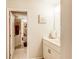 Bright bathroom featuring white vanity, mirror, and a separate room with a shower-tub combination at 230 Mackenzie Ct, Covington, GA 30016