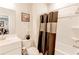 Clean bathroom with updated fixtures and a shower-tub combo, perfect for a refreshing start to the day at 230 Mackenzie Ct, Covington, GA 30016