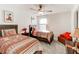 Bedroom featuring two beds, wood furniture, carpet flooring and light from window at 230 Mackenzie Ct, Covington, GA 30016