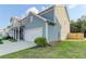 Charming two-story home with a white garage door, a well-manicured lawn, and a concrete driveway at 230 Mackenzie Ct, Covington, GA 30016