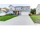 Charming two-story home with a well-maintained lawn and a paved driveway at 230 Mackenzie Ct, Covington, GA 30016