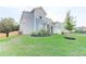 Well-maintained home featuring a grassy lawn, trees, and light-blue siding at 230 Mackenzie Ct, Covington, GA 30016