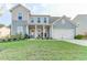 Charming two-story home with a well-manicured lawn, covered entryway, and attached garage at 230 Mackenzie Ct, Covington, GA 30016