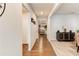 Hallway with wood flooring leading to carpeted living area with furniture and decor at 230 Mackenzie Ct, Covington, GA 30016