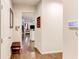 Inviting hallway featuring hardwood floors and a glimpse into the living area, creating a warm and welcoming entrance at 230 Mackenzie Ct, Covington, GA 30016