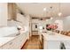 Modern kitchen featuring white cabinets, stainless appliances, an island and hardwood flooring at 230 Mackenzie Ct, Covington, GA 30016